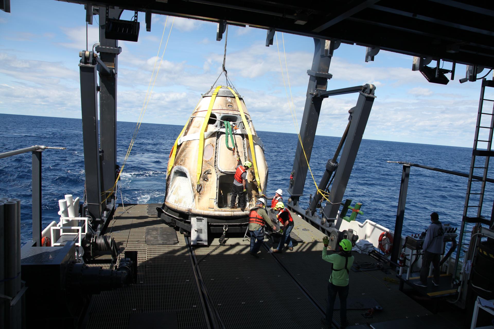 SpaceX Crew Dragon capsule being recovered from the Atlantic Ocean